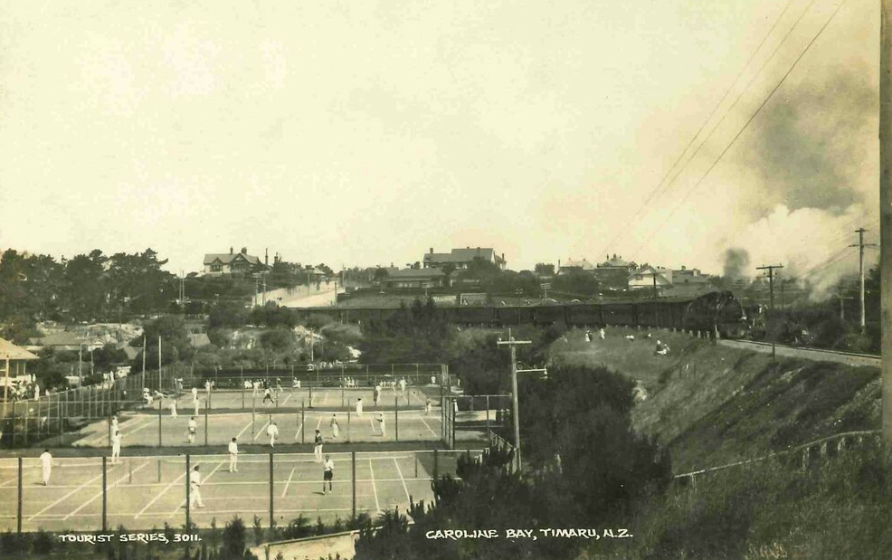 Postcard showing view of train heading around past the Tennis Courts at Caroline Bay c1920s